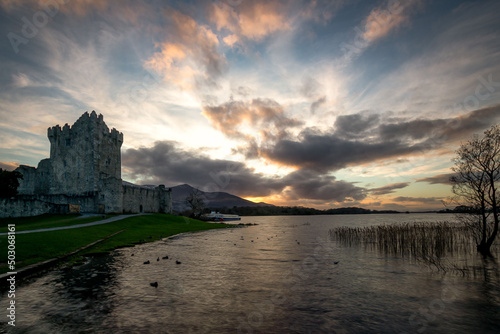 Beautiful lake in front of the old Roscommon Castle in Ireland under a cloudy sky