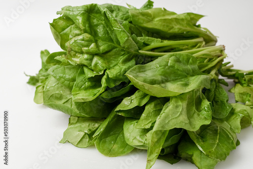Fresh spinach leaves on white isolated background