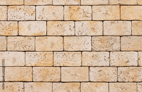 Brick wall, natural yellowish limestone stone. A specially prepared pattern for a seamless fill.