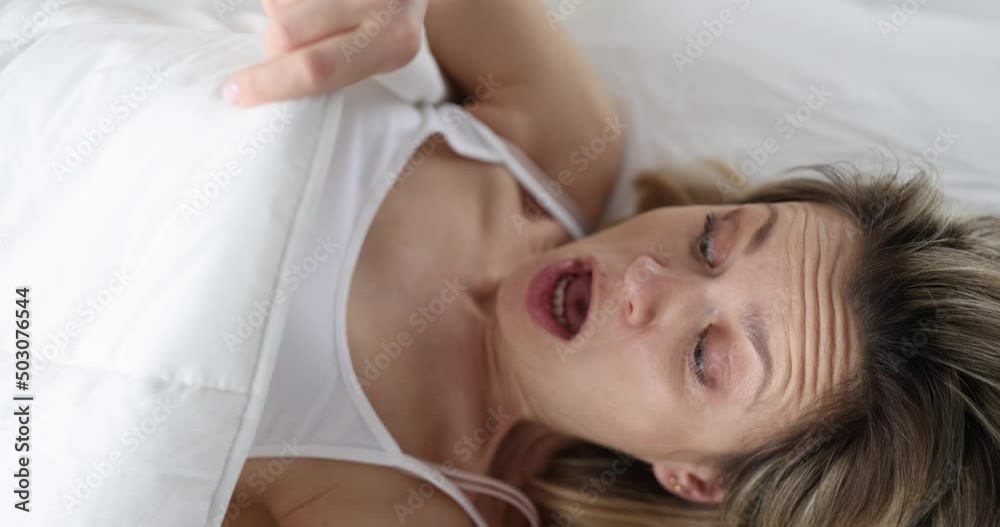 Young woman looking under covers and screaming 4k movie slow motion