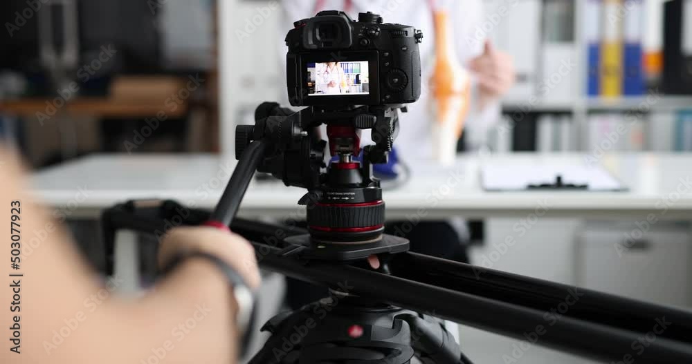 Videographer filming doctor on professional camera closeup 4k movie slow motion