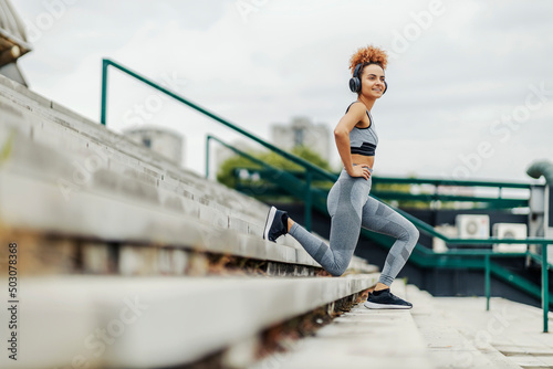 A sportswoman exercising on the stairs in the city.