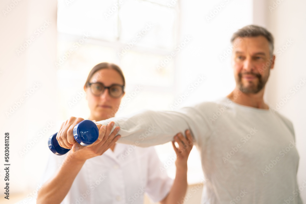 Physical Rehabilitation Therapist Helping Man Physical Rehabilitation Therapist Helping Man