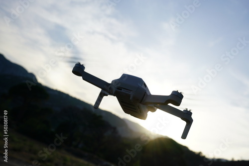Flying drone in the mountains at sunset. High quality photo