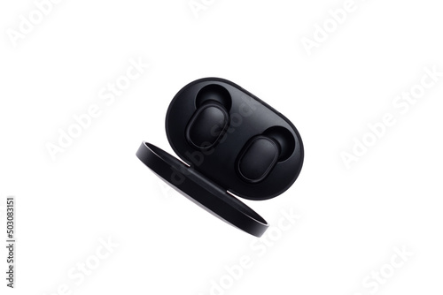 Wireless black bluetooth earphones with contactless charging isolated on a white background. Top view.