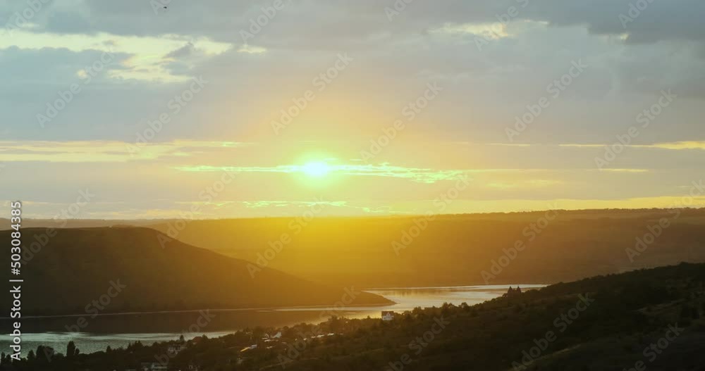 Sunset on the river in the canyon among the wooded hills Sunset on the river in the canyon among the wooded hills