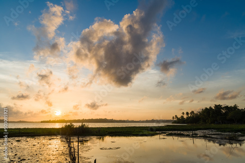 Sunset over a tropical lake with lotus flowers