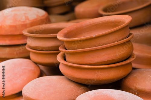 Traditional round clay pots for cooking on dispaly photo