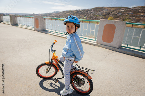 Happy child wearing a bike helmet outdoors