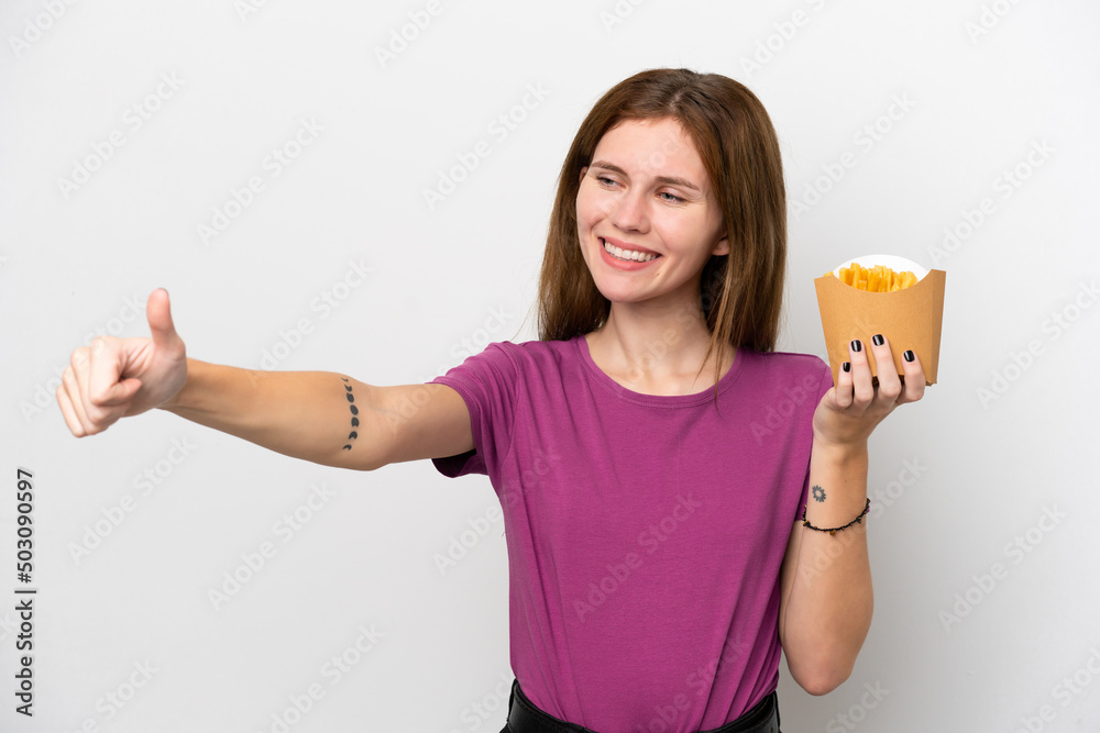 Young English woman holding fried chips isolated on white background giving a thumbs up gesture Young English woman holding fried chips isolated on white background giving a thumbs up gesture