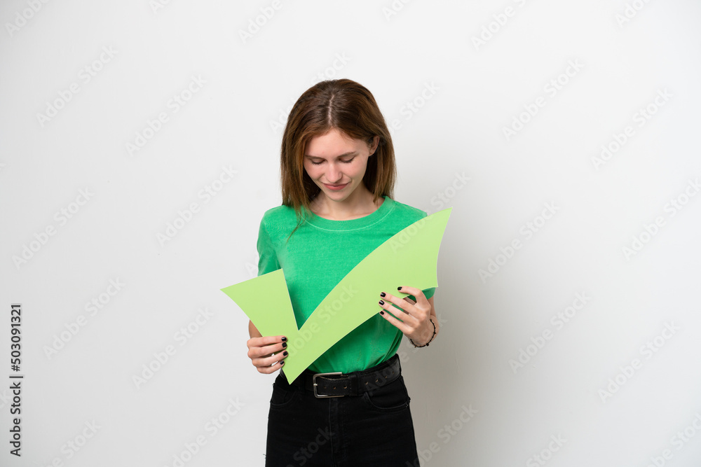 Young English woman isolated on white background holding a check icon and looking it Young English woman isolated on white background holding a check icon and looking it