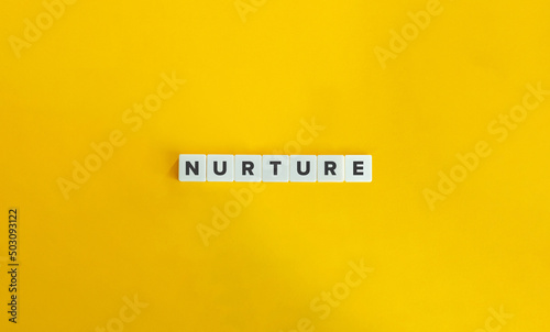 Nurture Word on Letter Tiles on Yellow Background. Minimal Aesthetics.