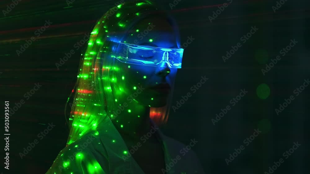 The young scientist in futuristic glasses on the laser rays background The young scientist in futuristic glasses on the laser rays background
