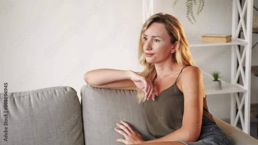 Disappointed situation. Sad woman. Regretful feelings. Beautiful lady pouting lips feeling frustration sitting sofa crossing hands light room interior. Disappointed situation. Sad woman. Regretful feelings. Beautiful lady pouting lips feeling frustration sitting sofa crossing hands light room interior.