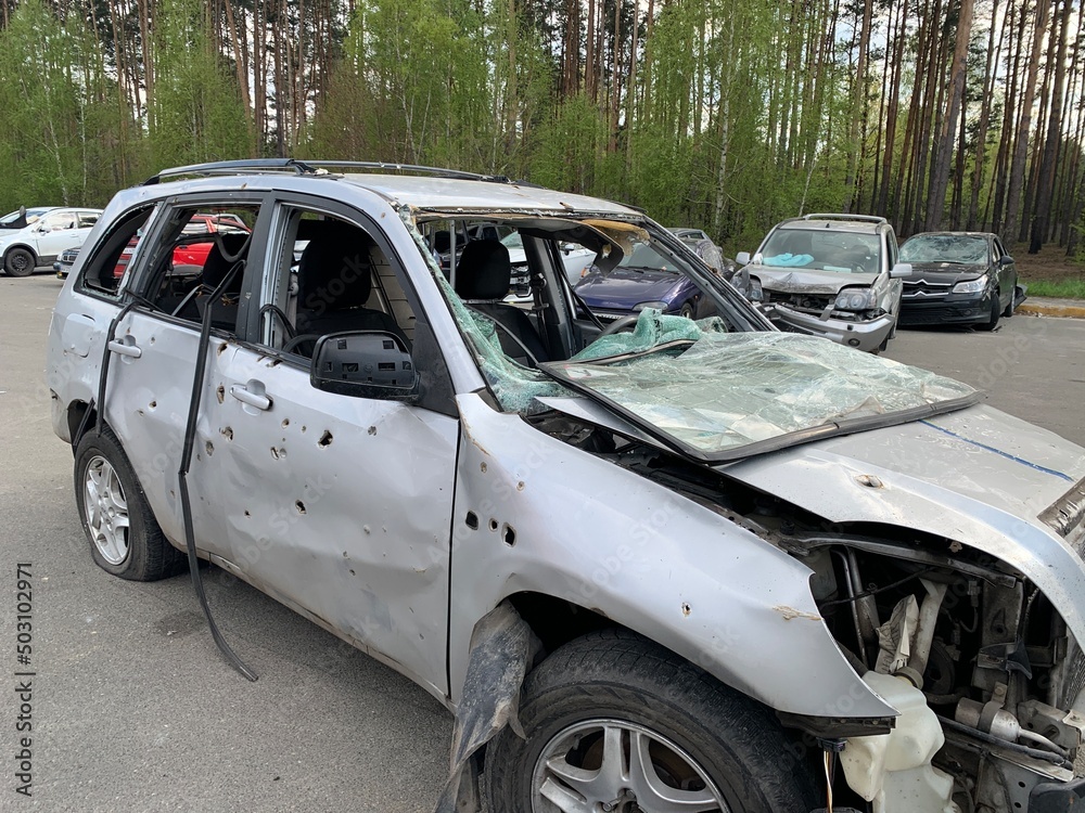 Burnt and blown up car. Cars damaged after shelling. Traces of shots on the body of the car. War between Russia and Ukraine, Irpin-Bucha, April 10, 2022 Burnt and blown up car. Cars damaged after shelling. Traces of shots on the body of the car. War between Russia and Ukraine, Irpin-Bucha, April 10, 2022