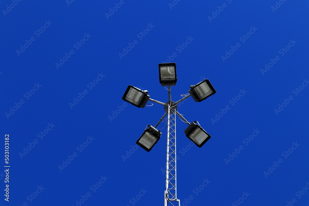 Five headlight at one post. Street lamp. Copy space with a clear blue sky. Five headlight at one post. Street lamp. Copy space with a clear blue sky.