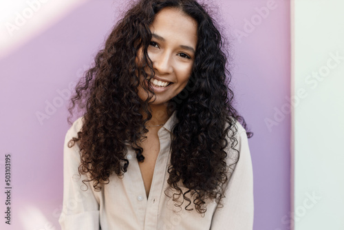 pretty young woman outdoor portrait near purple wall