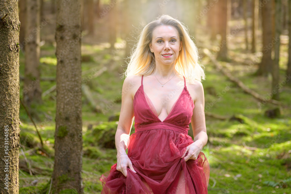 Sensuous blond woman in magenta dress at woods. Sensuous blond woman in magenta dress at woods.