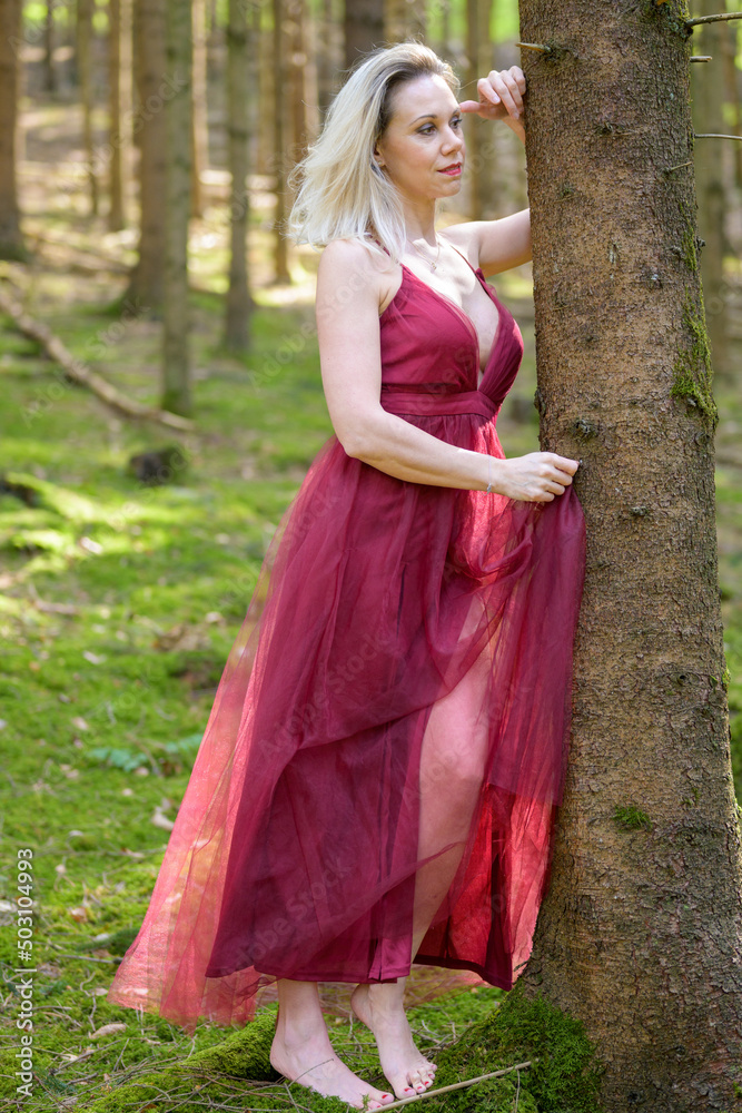 Beautiful woman wearing sexy gown in forest. Beautiful woman wearing sexy gown in forest.