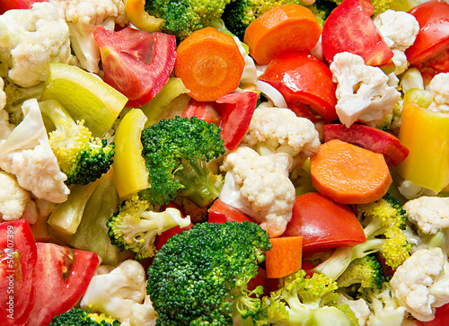 Food background. Bright coarsely chopped fresh vegetables. Vegetable stew with broccoli, cauliflower, carrots, bell peppers. Natural healthy food.