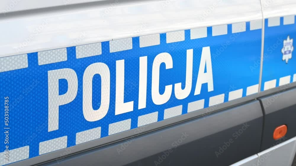 Police patrol car parked on the street in Poland. Polish police car on the street. Side view of a police car with the lettering Police patrol car parked on the street in Poland. Polish police car on the street. Side view of a police car with the lettering