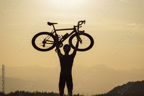 Man road cycling on race bike outdoor in nature