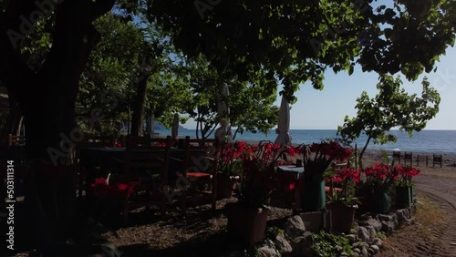 Beautiful Mediterranean restaurant on the beach on a sunny morning. High quality 4k footage