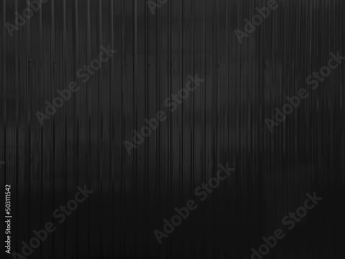 dark black metal sheet wall with corrugated pattern texture use as background. black metallic or zinc wall background for industrial concept.
