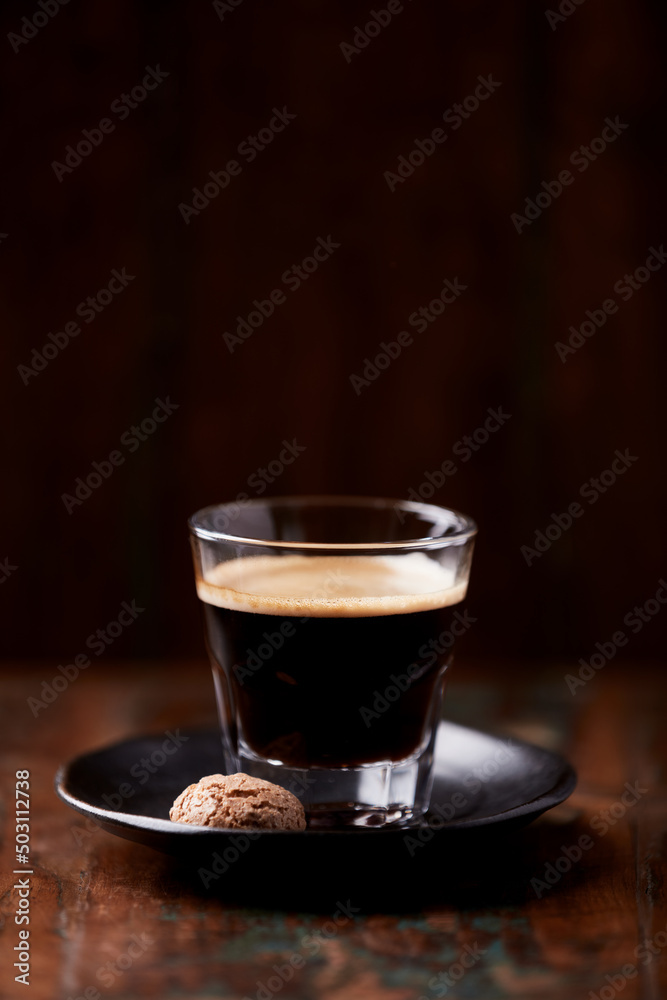 Coffee in glass cup on dark wooden background. Copy space. Coffee in glass cup on dark wooden background. Copy space.