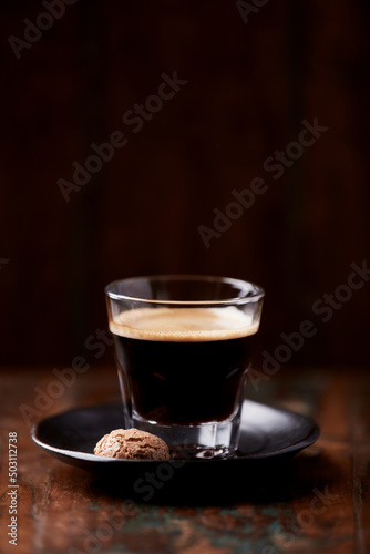  Coffee in glass cup on dark wooden background. Copy space. 
