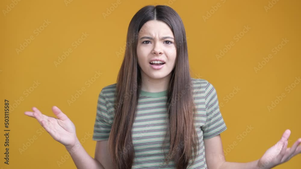 Schoolgirl not hear ask stop loud sound isolated vivid color background Schoolgirl not hear ask stop loud sound isolated vivid color background
