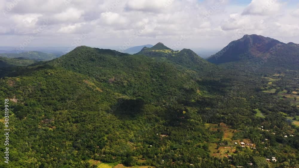 Top view of Mountain slopes with rainforest and a mountain valley with farmland.Sri Lanka. Top view of Mountain slopes with rainforest and a mountain valley with farmland.Sri Lanka.