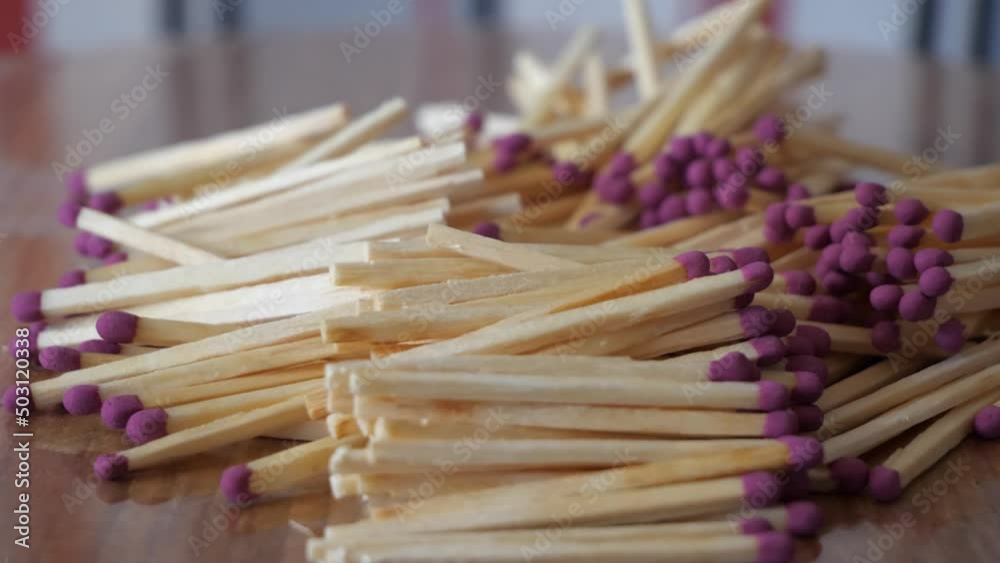Lots of matches on a rotating surface, side view. Matches close-up. Highly detailed 4k macro video. A bunch of matches.