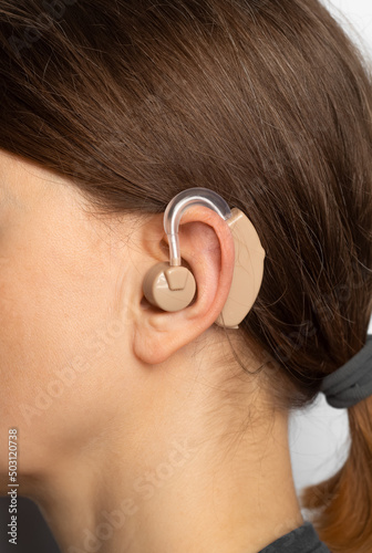 Hearing aid on a woman's ear, close-up.