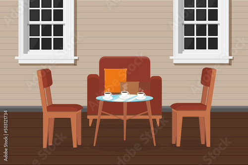 armchair chairs and a table with coffee on the veranda of the house with windows terrace cafe