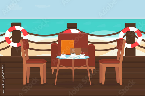 terrace of the restaurant with chairs and tables on a sandy beach near the sea
