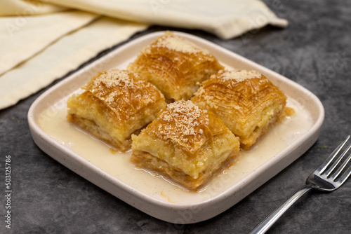 Milk baklava. Baklava with hazelnuts on a dark background. Mediterranean cuisine delicacies. Close-up. local name sutlu nuriye baklava