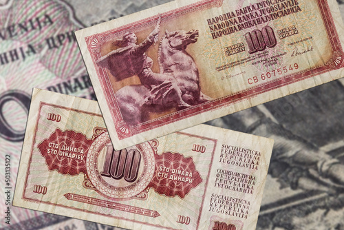 фотографія Top view of red old damaged weathered Yugoslavian 100 dinars banknotes