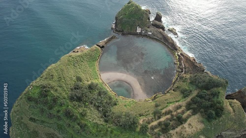 Famous volcanic islet of Vila Franca do Campo, small green crater island near sea shore with rocks ocean, Sao Miguel, Azores, Portugal