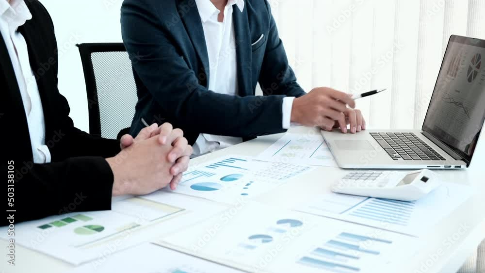 Business meeting, Businessman is summarizing financial graphs and analyzing market trends from a laptop to develop a company's revenue, Brainstorming or Discussing concept. Business meeting, Businessman is summarizing financial graphs and analyzing market trends from a laptop to develop a company's revenue, Brainstorming or Discussing concept.