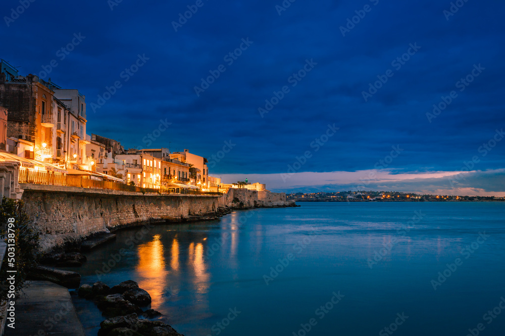 Fototapeta premium Long exposure of Ortigia at sunset on the sea