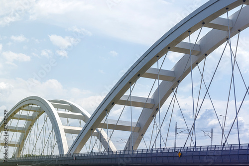 Modern metal bridge against the blue sky background.