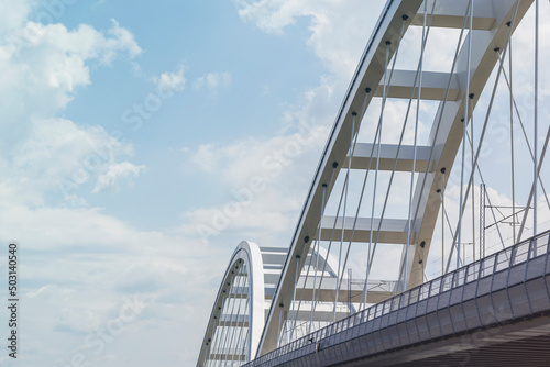 Modern metal bridge against the blue sky background.