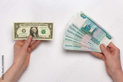 Russian rubles and US dollar holding in hands on white background