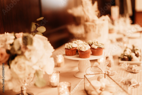 Selective focus shot of cupcakes with cream toppings on the white salver for a romantic dinner