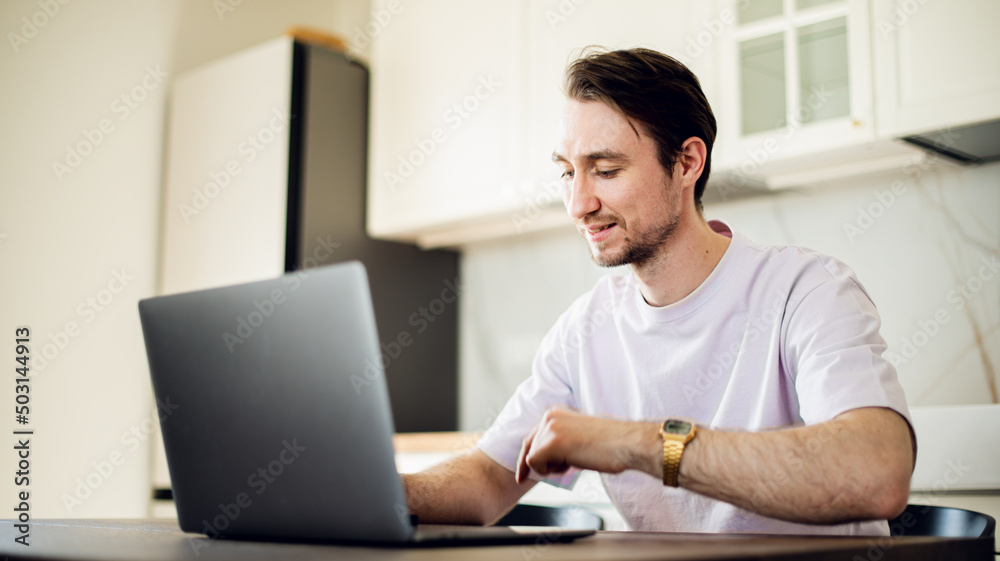 Man at laptop at home workplace chooses the point of destination for trip or working at home, studding on online courses with internet. Man at laptop at home workplace chooses the point of destination for trip or working at home, studding on online courses with internet.