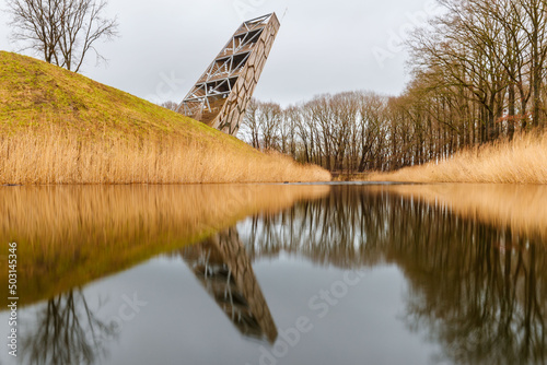 Watchtower of the Fort of Rovere in North Brabant with trees and water reflection photo