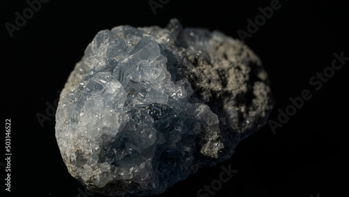 Принти на полотні Closeup of sky blue celestine crystal gemstone on a reflective black surface