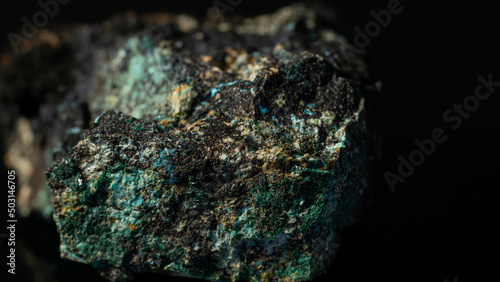 Closeup of a Chalcocite, copper sulfide isolated on a black background photo