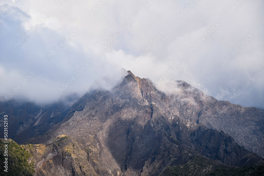 A mysterious mountain peak is soaking in a smoky cloud  in Japanese mountain retreat